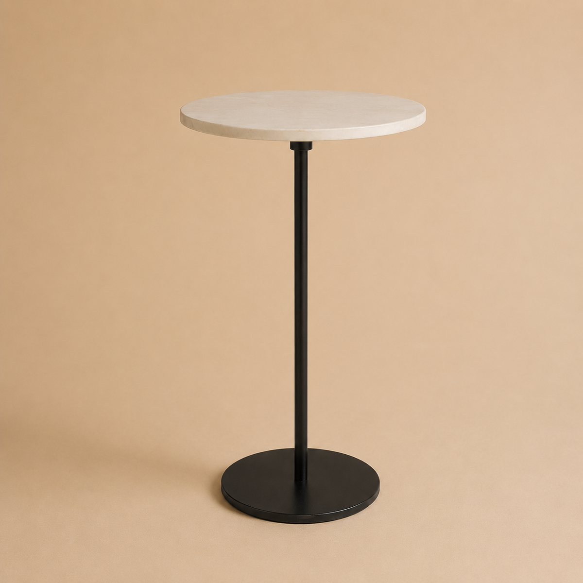 Round side table with white top and black base on a beige background