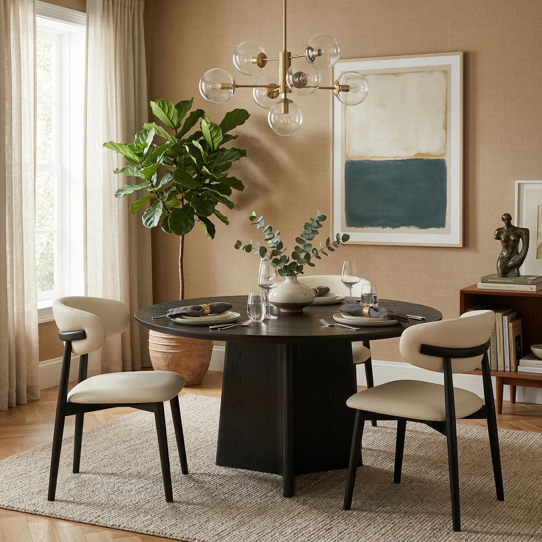 Four cream leather and black ash wood dining chairs styled around a modern round black dining table in a warm, contemporary dining room.