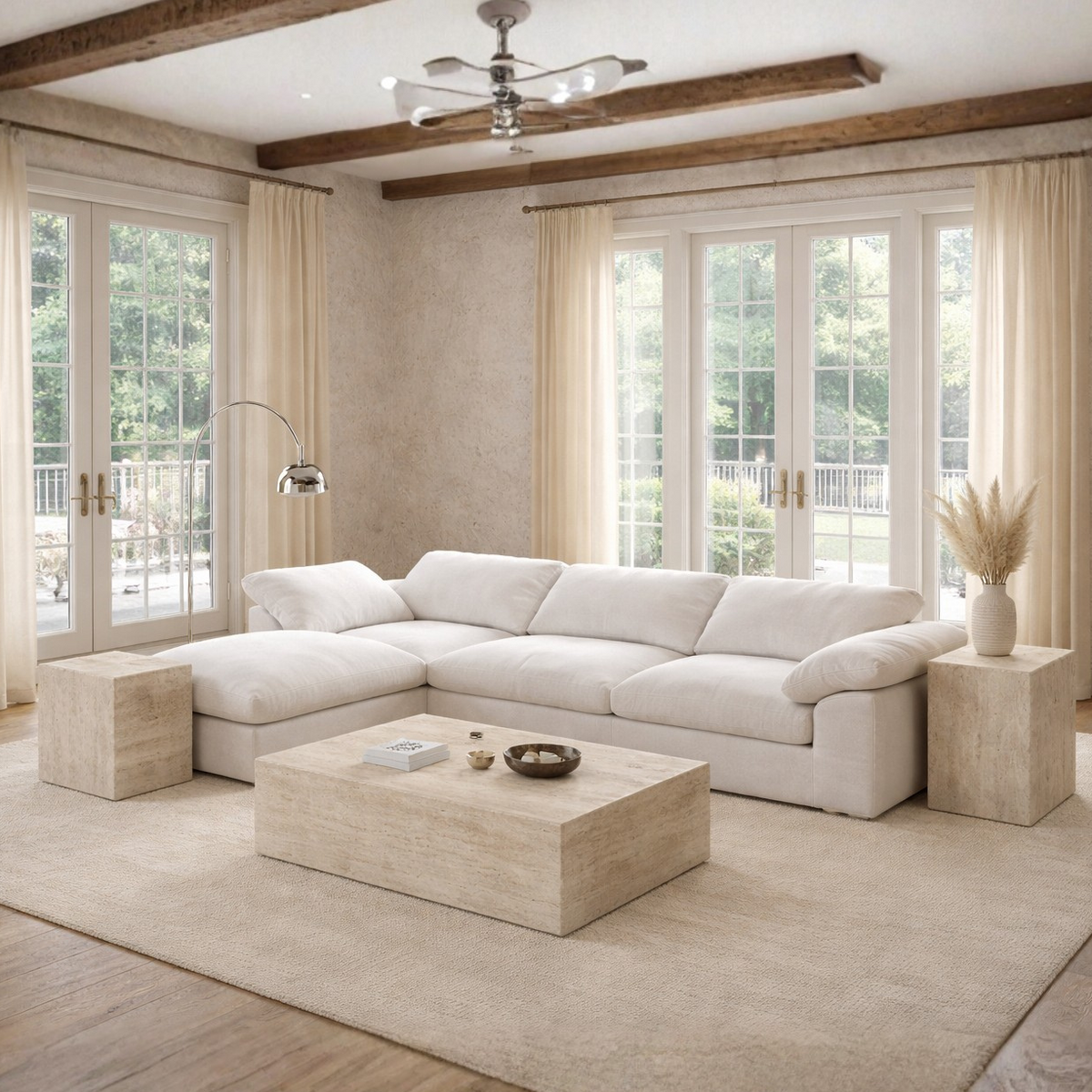 Modern living room with a white sectional sofa, travertine pattern beige coffee table, and large windows.