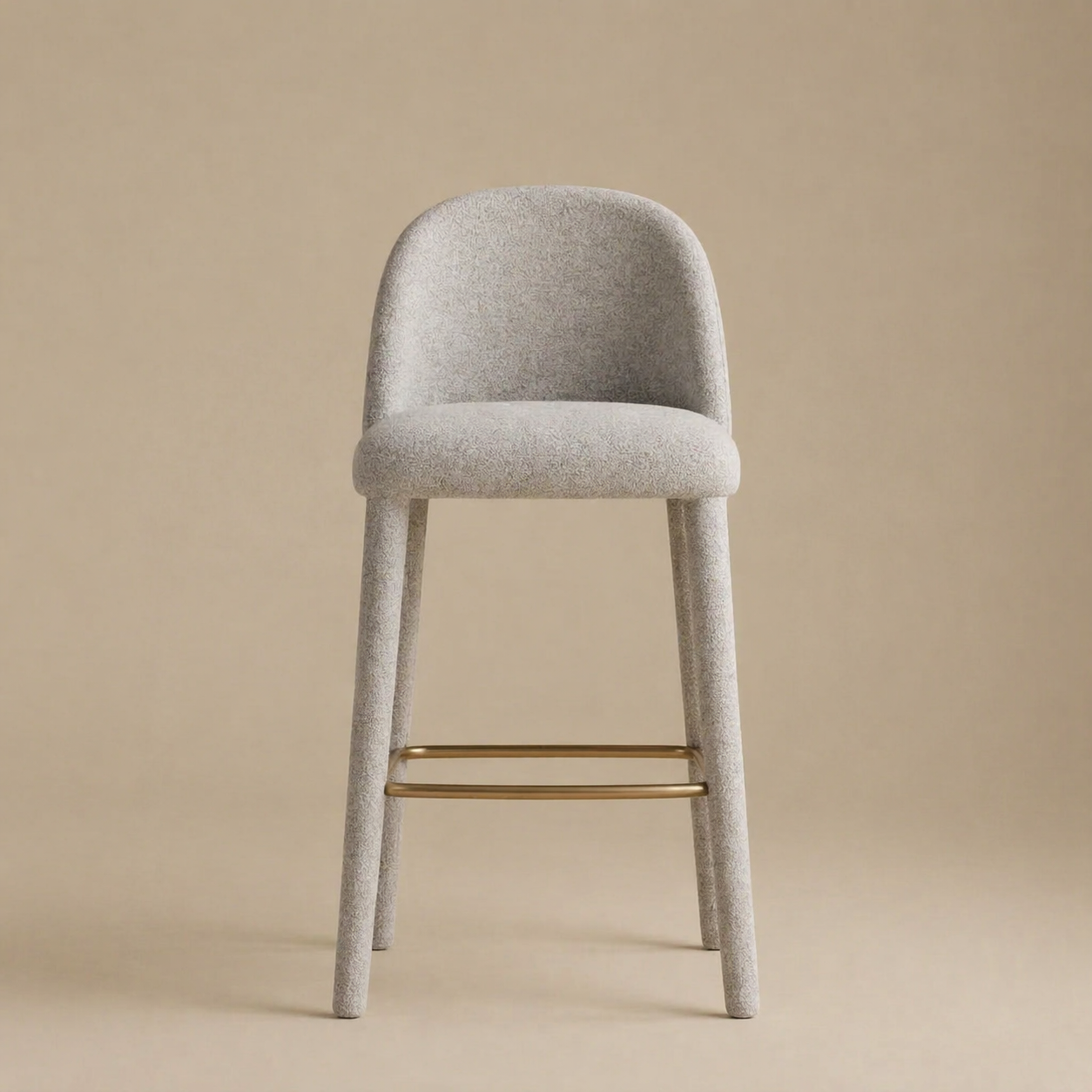 Gray bar stool with gold metal legs on a beige background