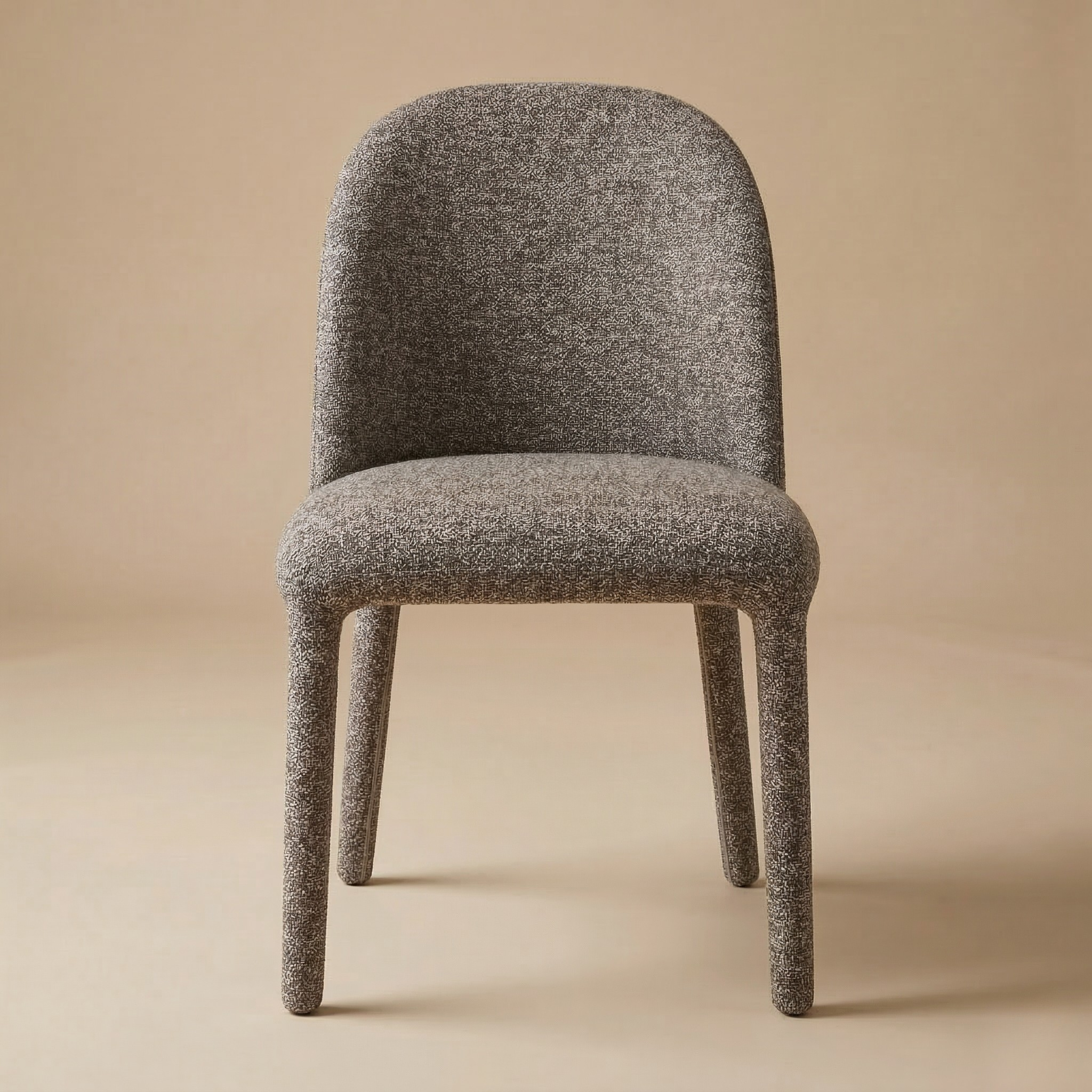 Full front view of the Myla dining chair featuring a curved backrest and fully upholstered textured dark brown fabric legs.