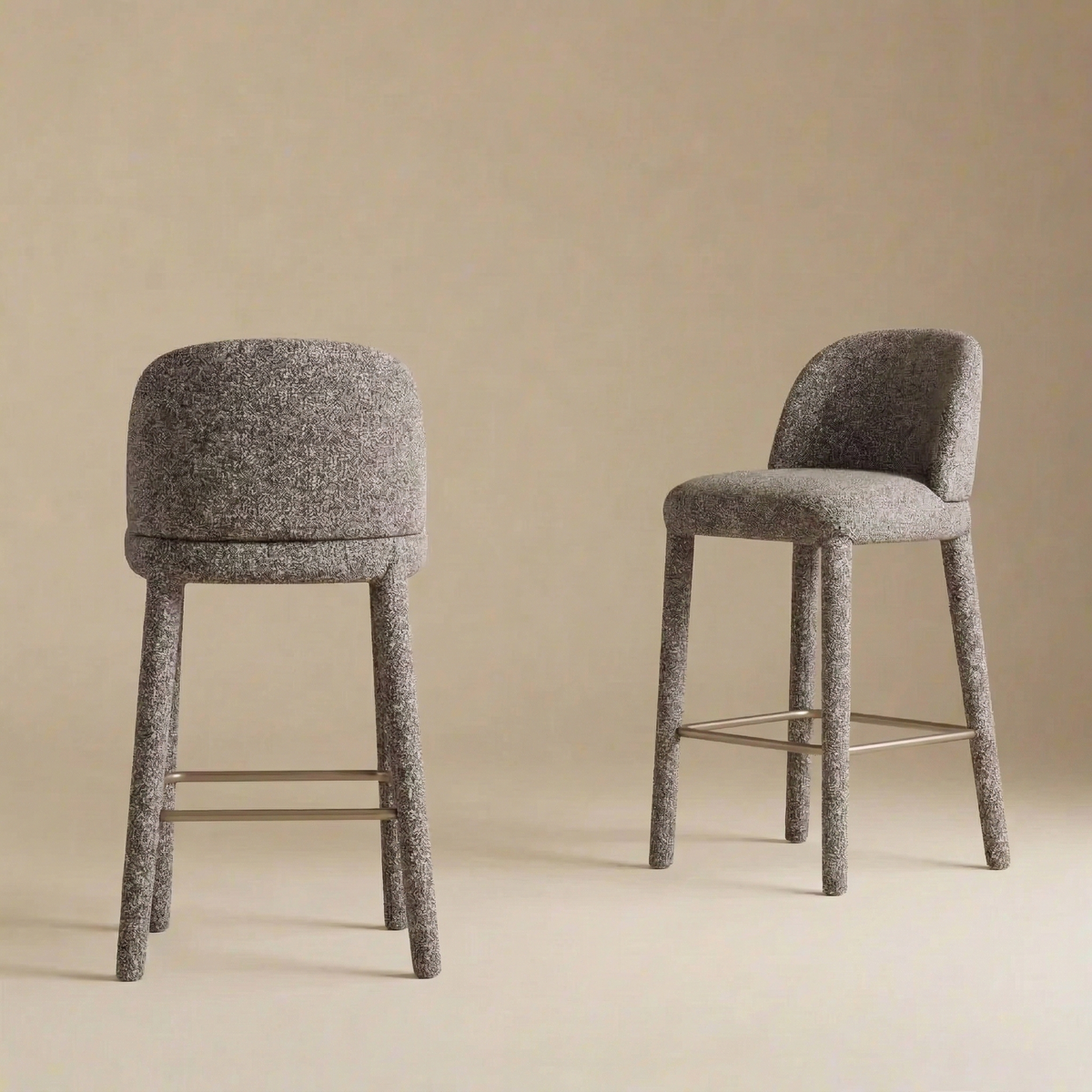 Pair of grey Myla Counter Stools showing the curved backs and seamless upholstery