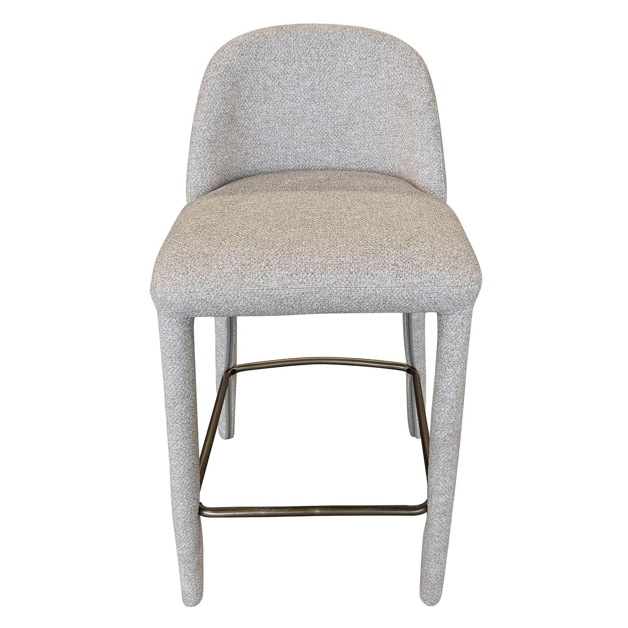 Full front view of the Myla counter stool featuring a curved, hugging backrest and plush textured beige upholstery.