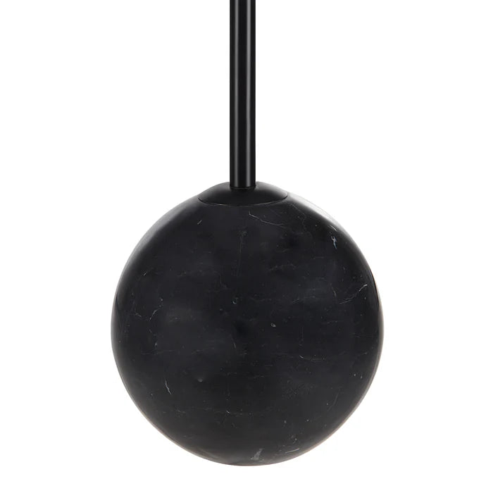 Macro close-up of the Nox lamp highlighting the polished black marble base and matching matte black metal stem.