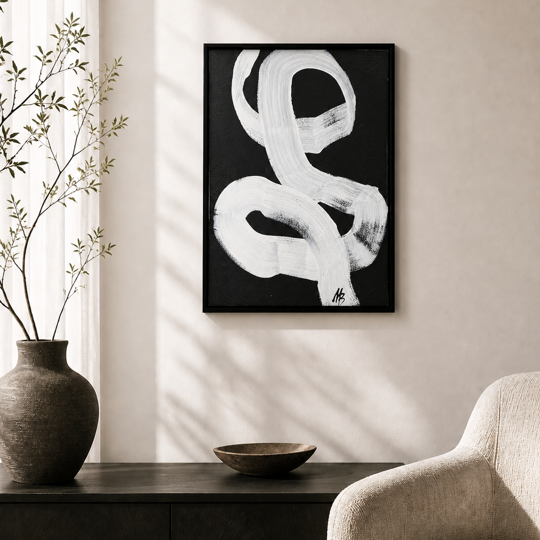 Abstract black and white painting on a wall in a living room setting.
