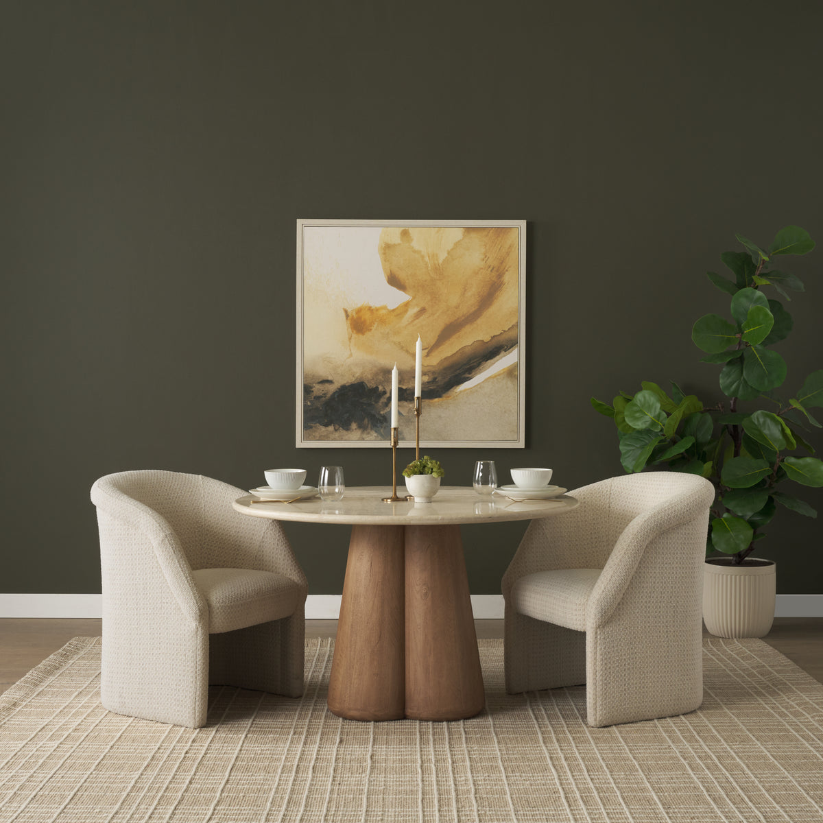 Two Octavia cream dining armchairs styled around a round dining table
