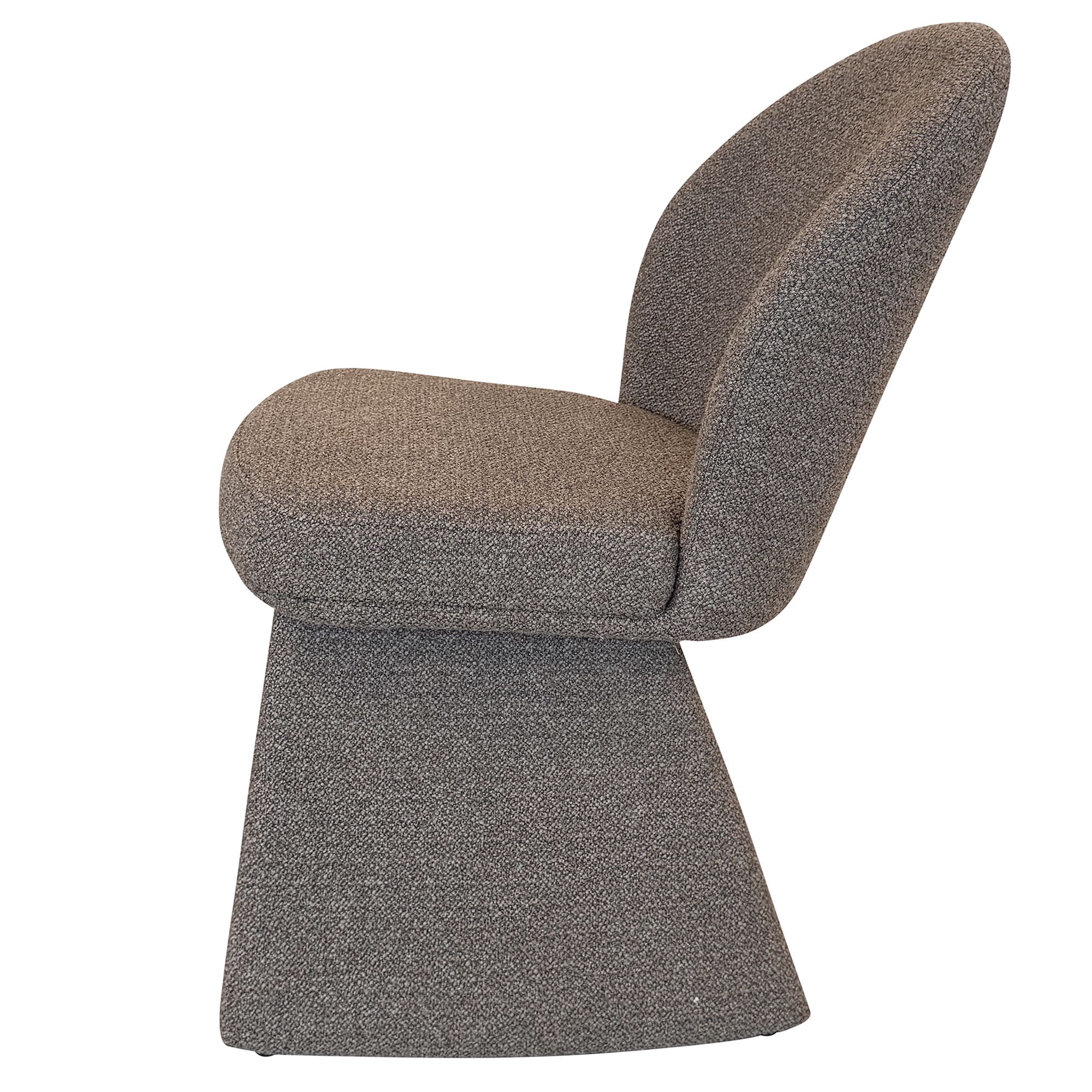 Direct side profile of the Odette chair in charcoal color showcasing the ergonomic curve of the back and the substantial block-style base.