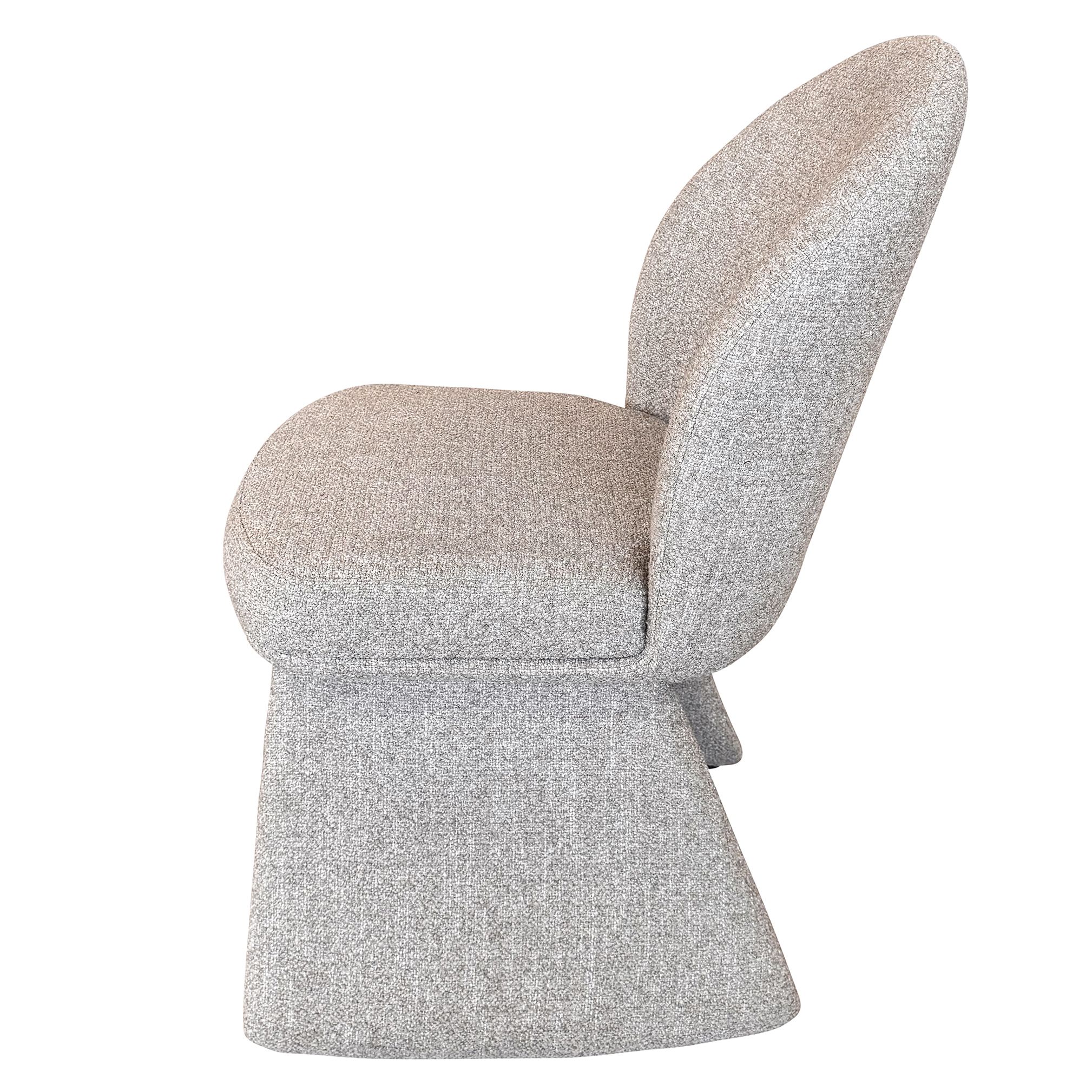 Direct side profile of the Odette chair showcasing the ergonomic curve of the back and the substantial block-style base.