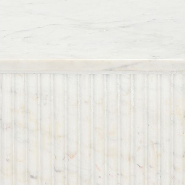 Fluted marble table base detail with veining pattern