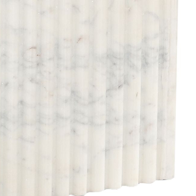Fluted marble table base detail with veining pattern