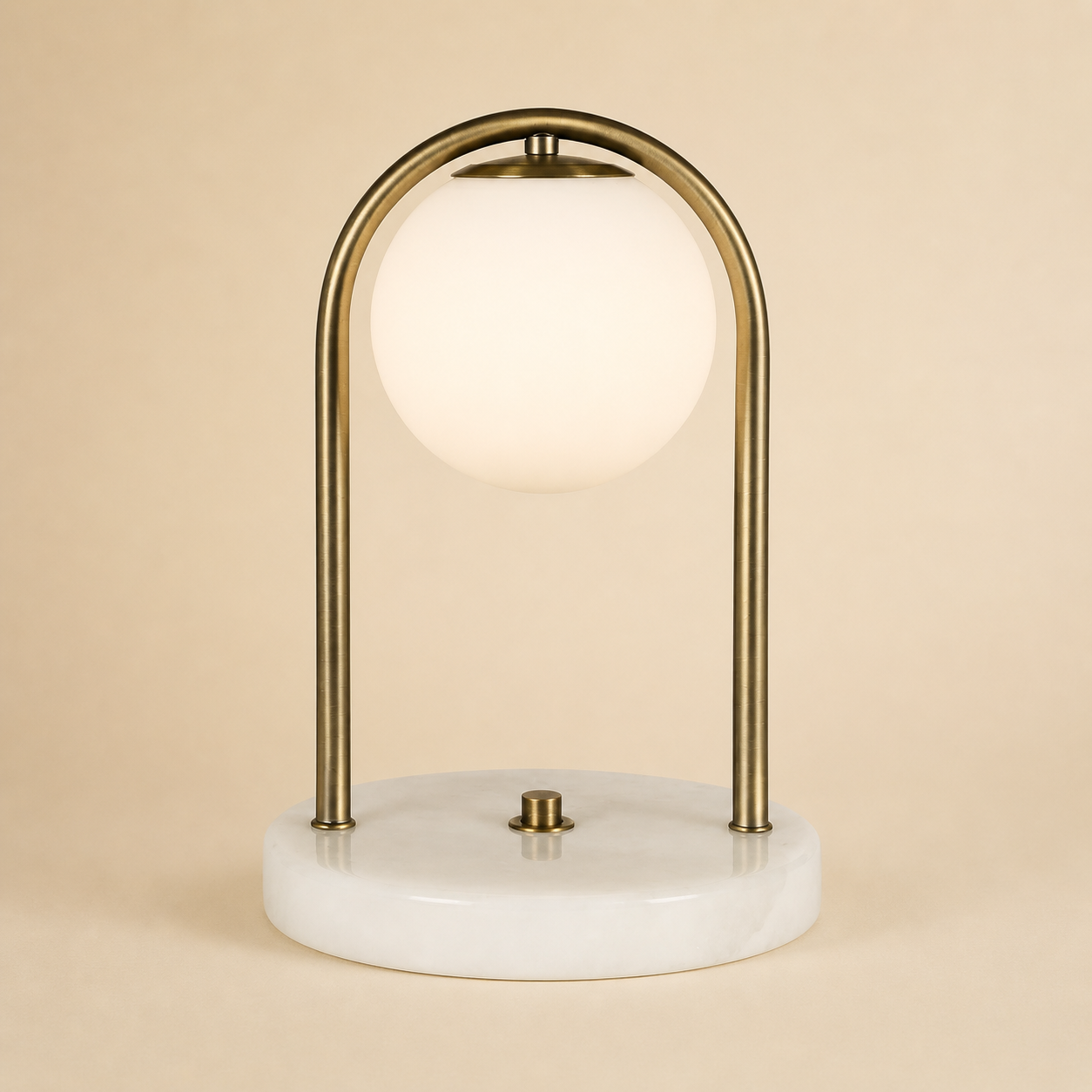 Table lamp with gold arch and marble base on a beige background