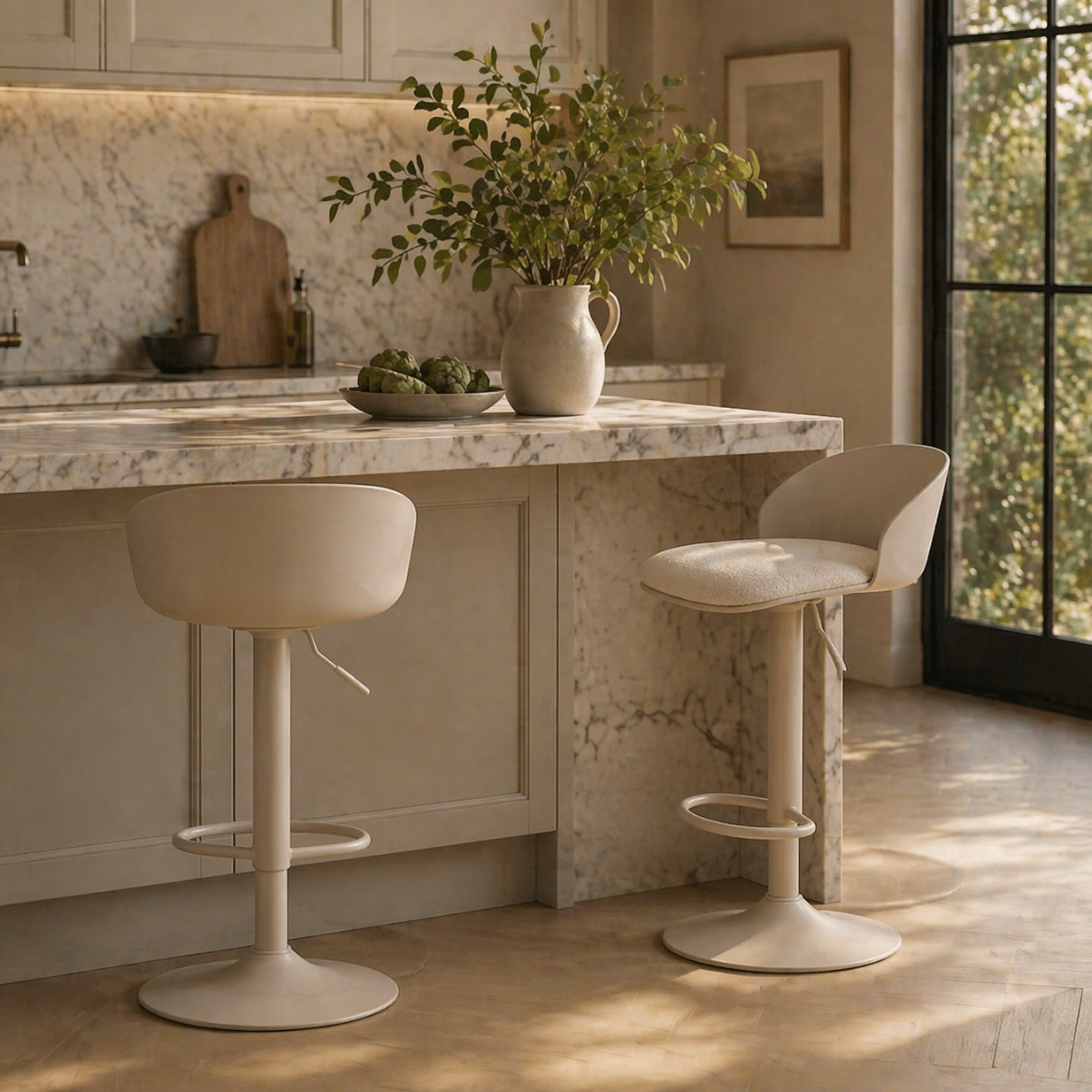 Modern kitchen with marble island and bar stools, featuring a vase with greenery.