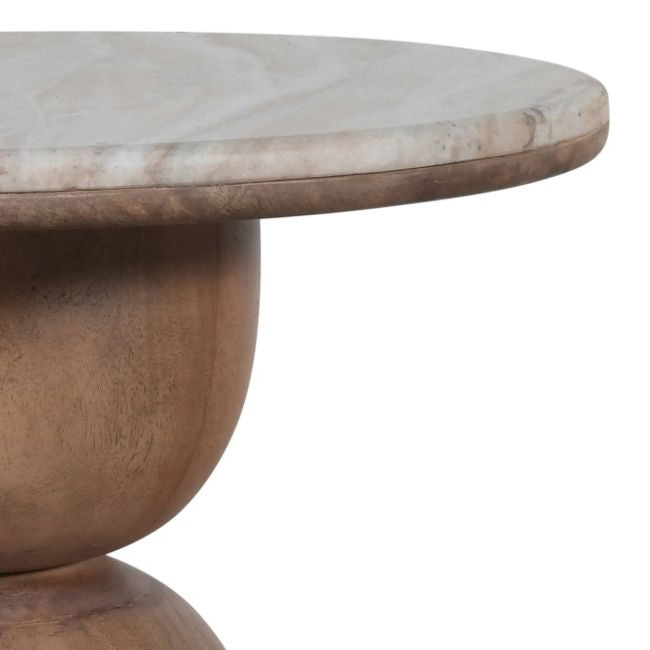 Corner close-up of the round wooden table with a marble top on a white background