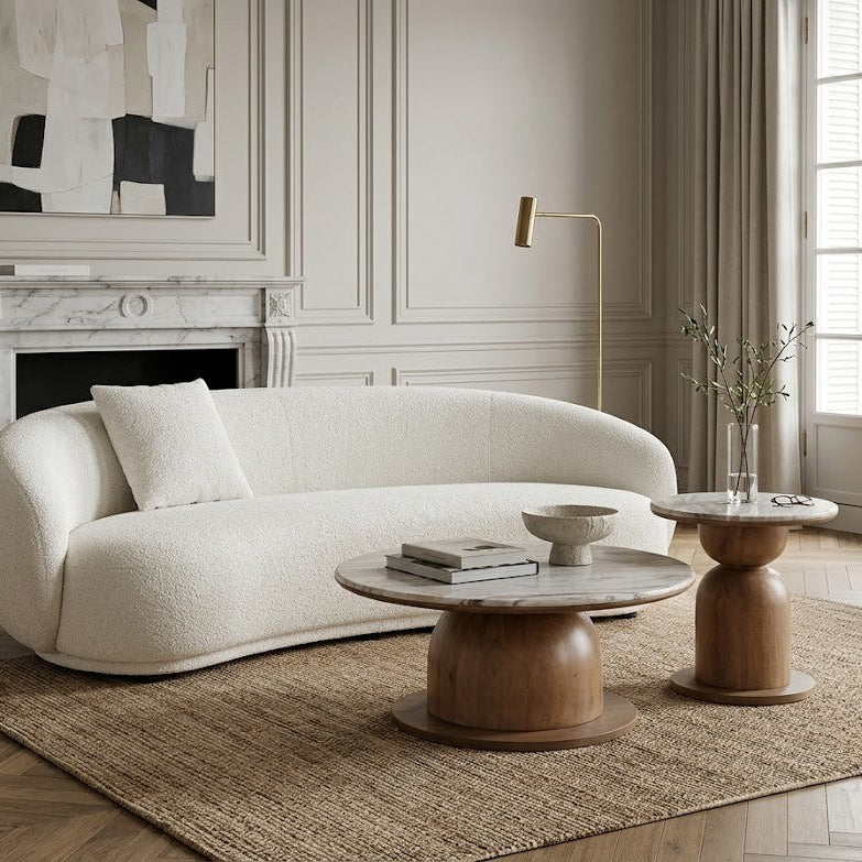 Modern living room with a boucle sofa, marble and wooden coffee table and side table.