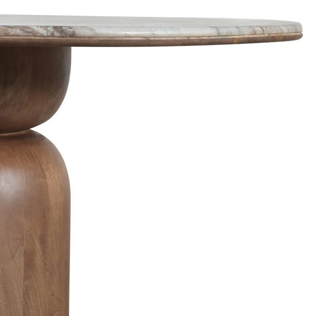 Corner details of the Ottilie dining table with a marble top on a white background