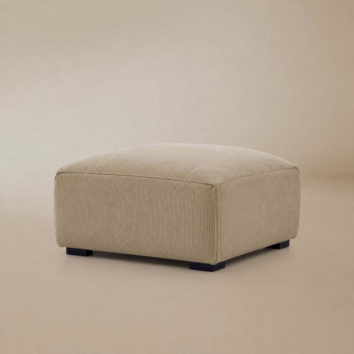 A square corduroy ottoman shown on a beige studio background.