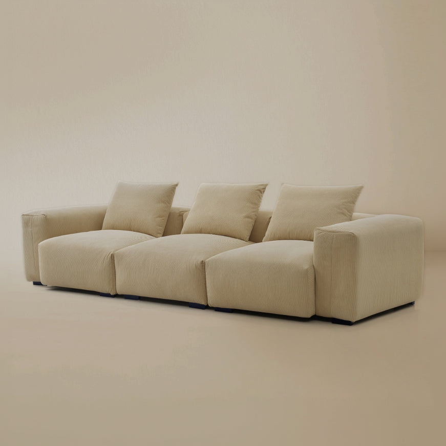 Angle view of the beige plush corduroy modular sofa in a studio background