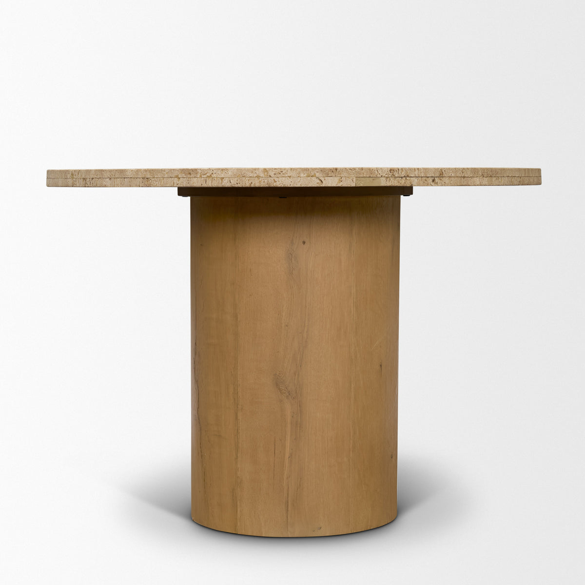 Side view of the Romina dining table showing its travertine top and cylindrical oak pedestal