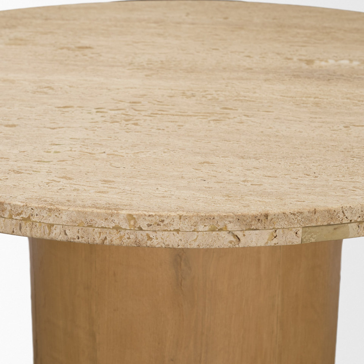 Detailed view of the Romina table’s sandblasted travertine surface and substantial rounded edge