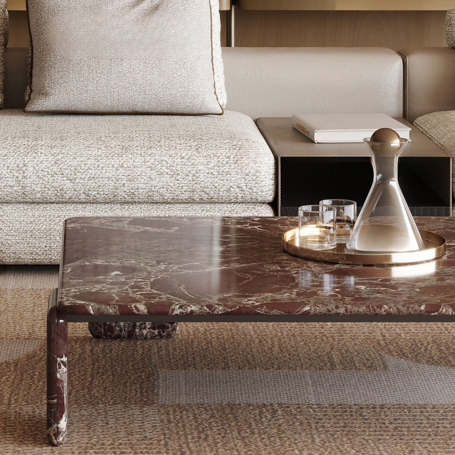 The Rosso Forma coffee table styled in a luxury living room with a gold tray and crystal decanter on a textured brown rug.