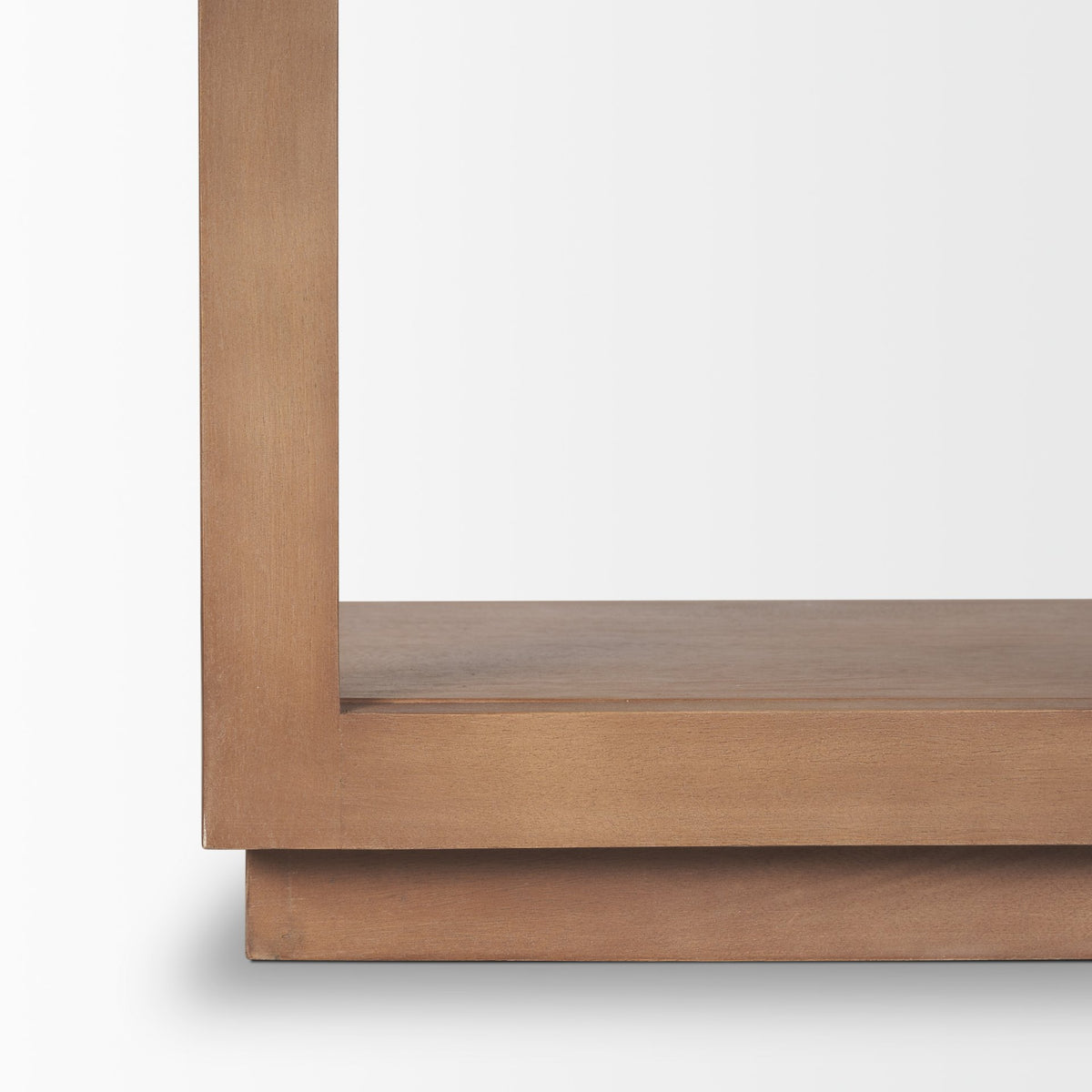 Close-up of the sturdy, layered wooden base and bottom shelf on the Rowan arched bookcase.