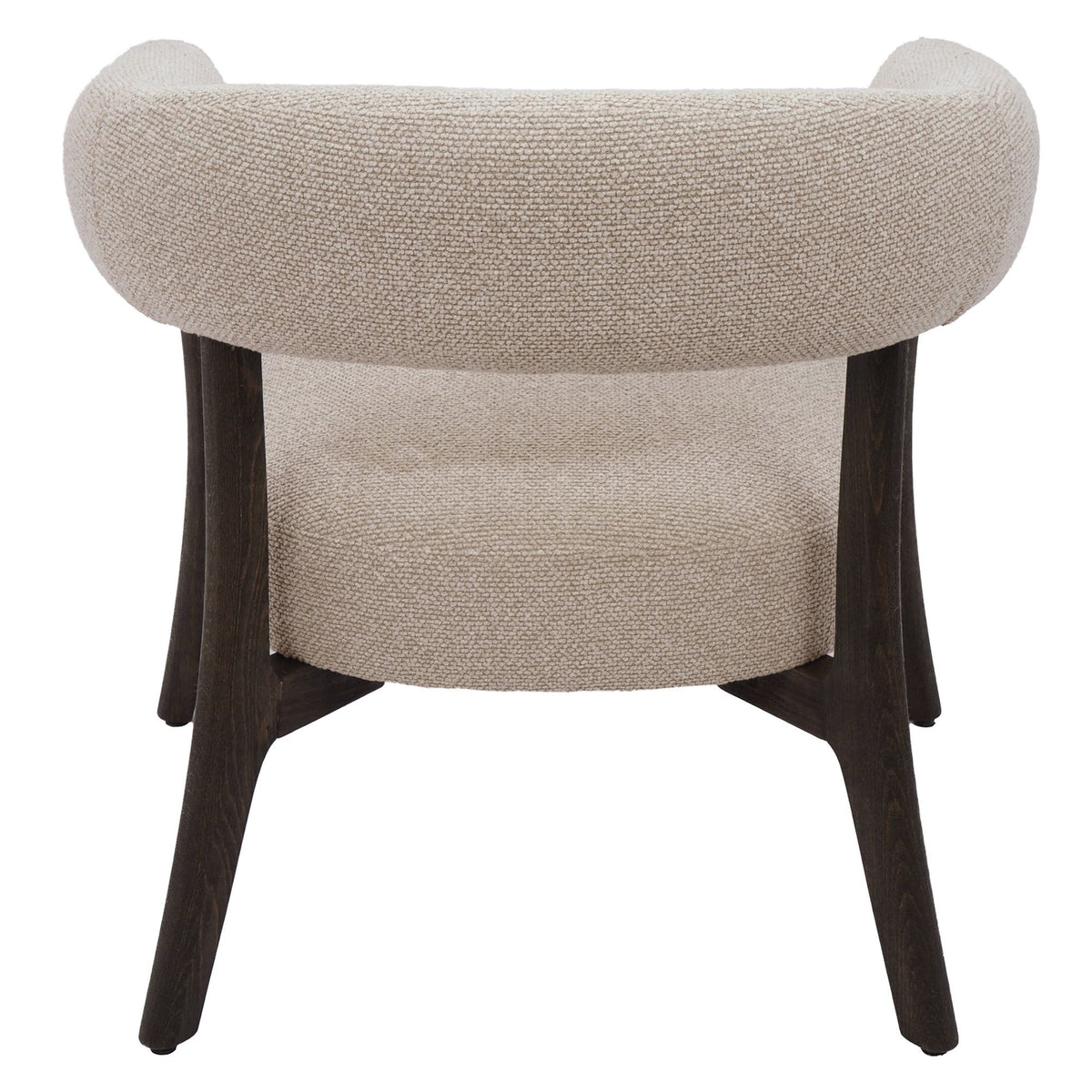 Rear studio view of the Rowan accent chair showcasing the continuous curve of the backrest and architectural dark wood base.