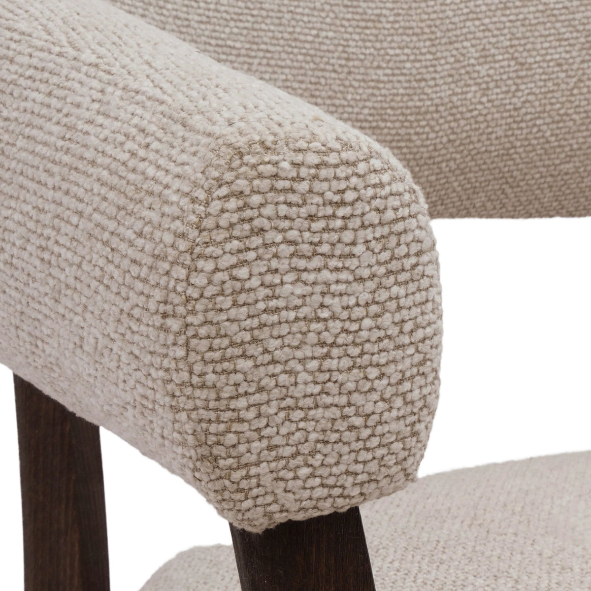 Close-up macro shot of the Rowan chair's oat bouclé fabric, showcasing the rich, nubby texture and high-quality weave.