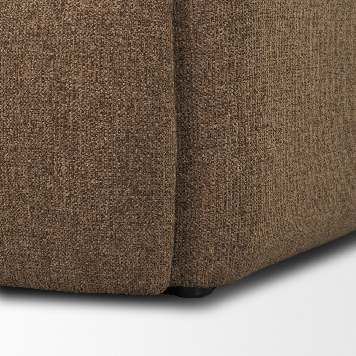 Close up of the bottom corner of the Rowan chair showing the durable mocha upholstery.