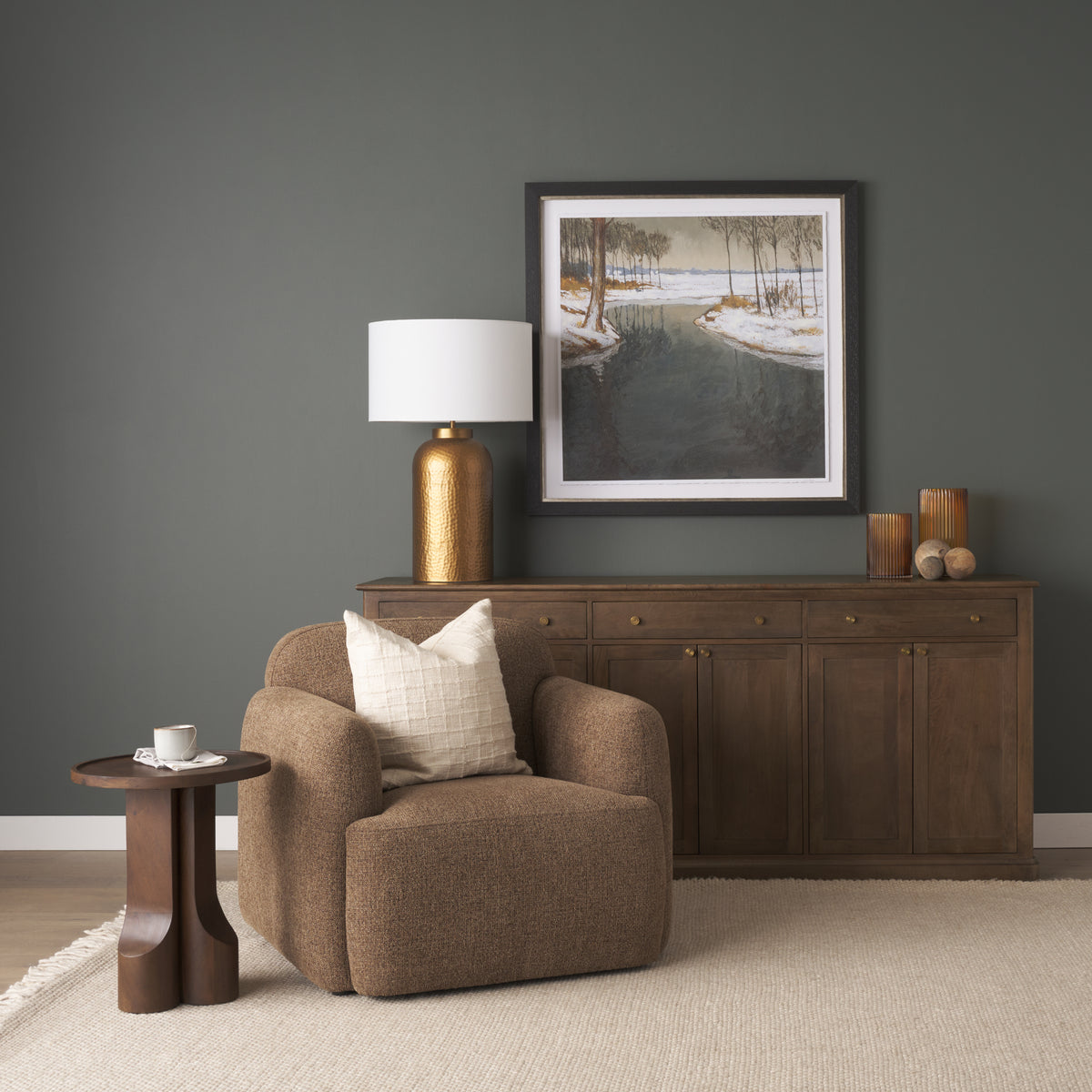 Rowan mocha accent chair styled in a modern living room next to a dark wood sideboard and gold table lamp.
