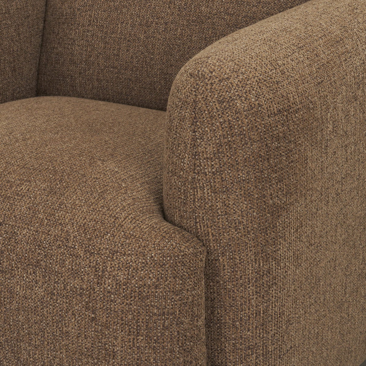 Detail shot of the plush seat cushion and rounded armrest on the Rowan mocha accent chair.