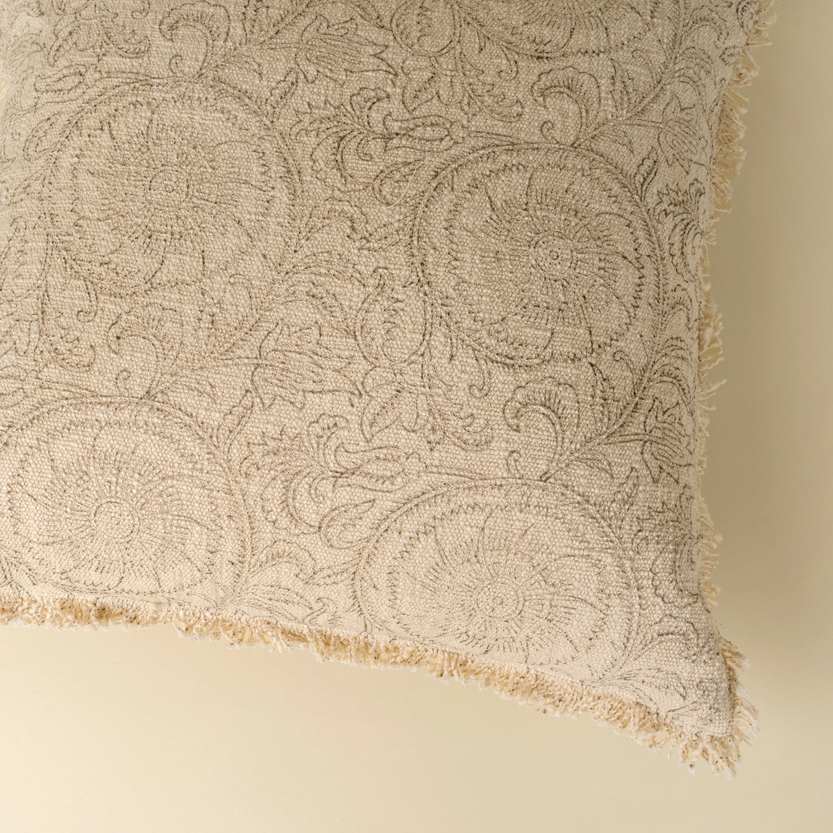 Textured fabric with intricate patterns on a beige background