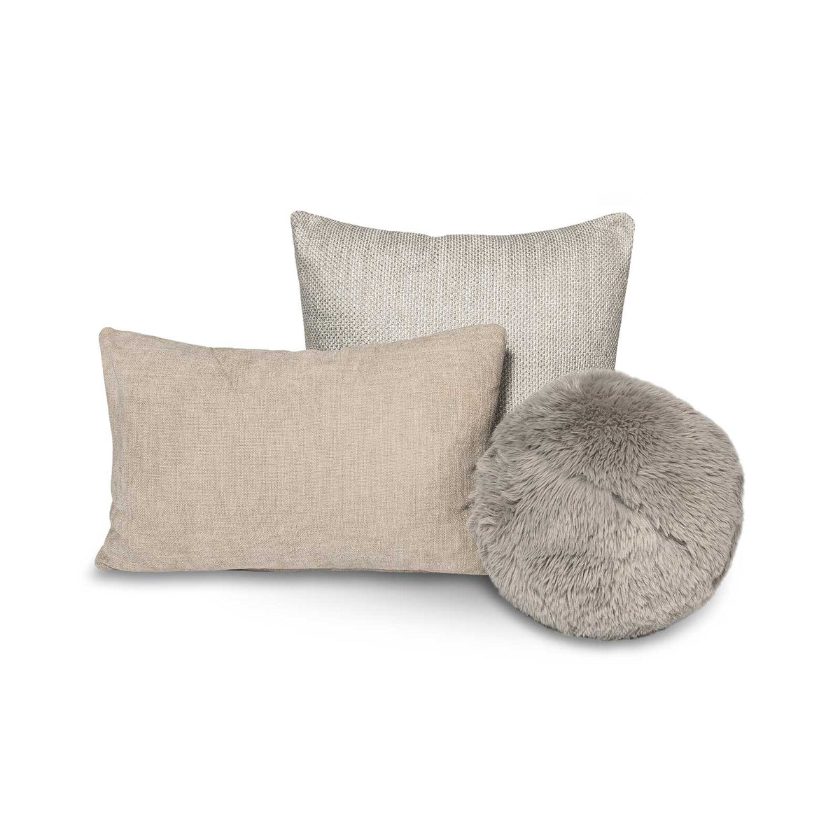 A set of three Serenity cushions in natural tones, including a rectangular linen pillow, a woven square, and a round faux fur cushion.