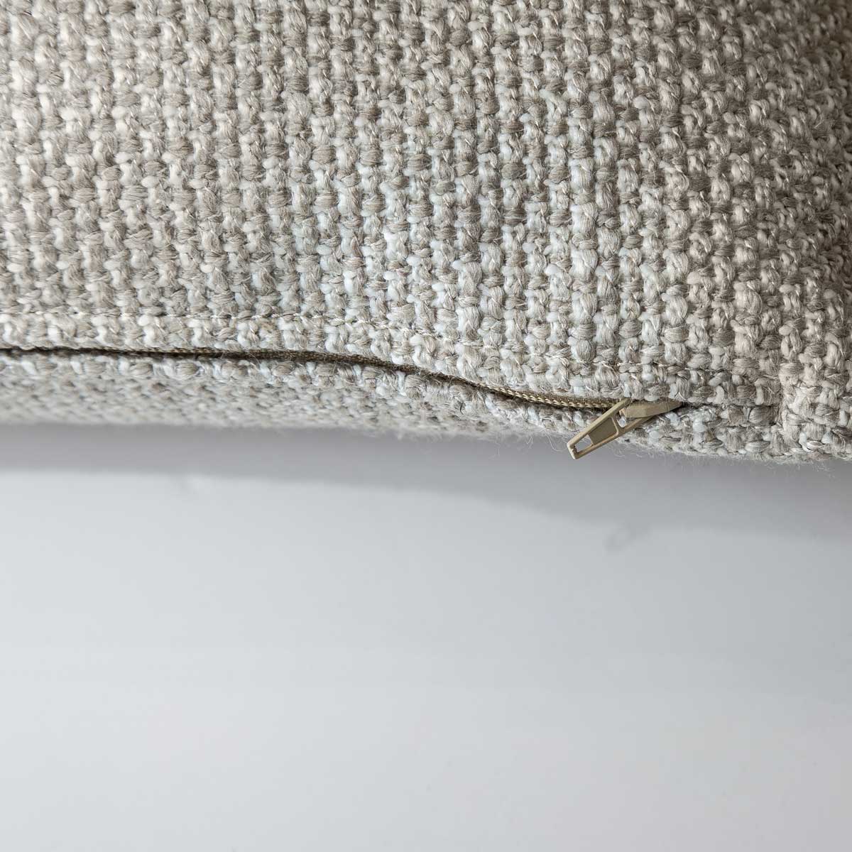 Macro view of the textured woven cushion from the Serenity trio, showcasing the durable fabric and precise edge stitching.