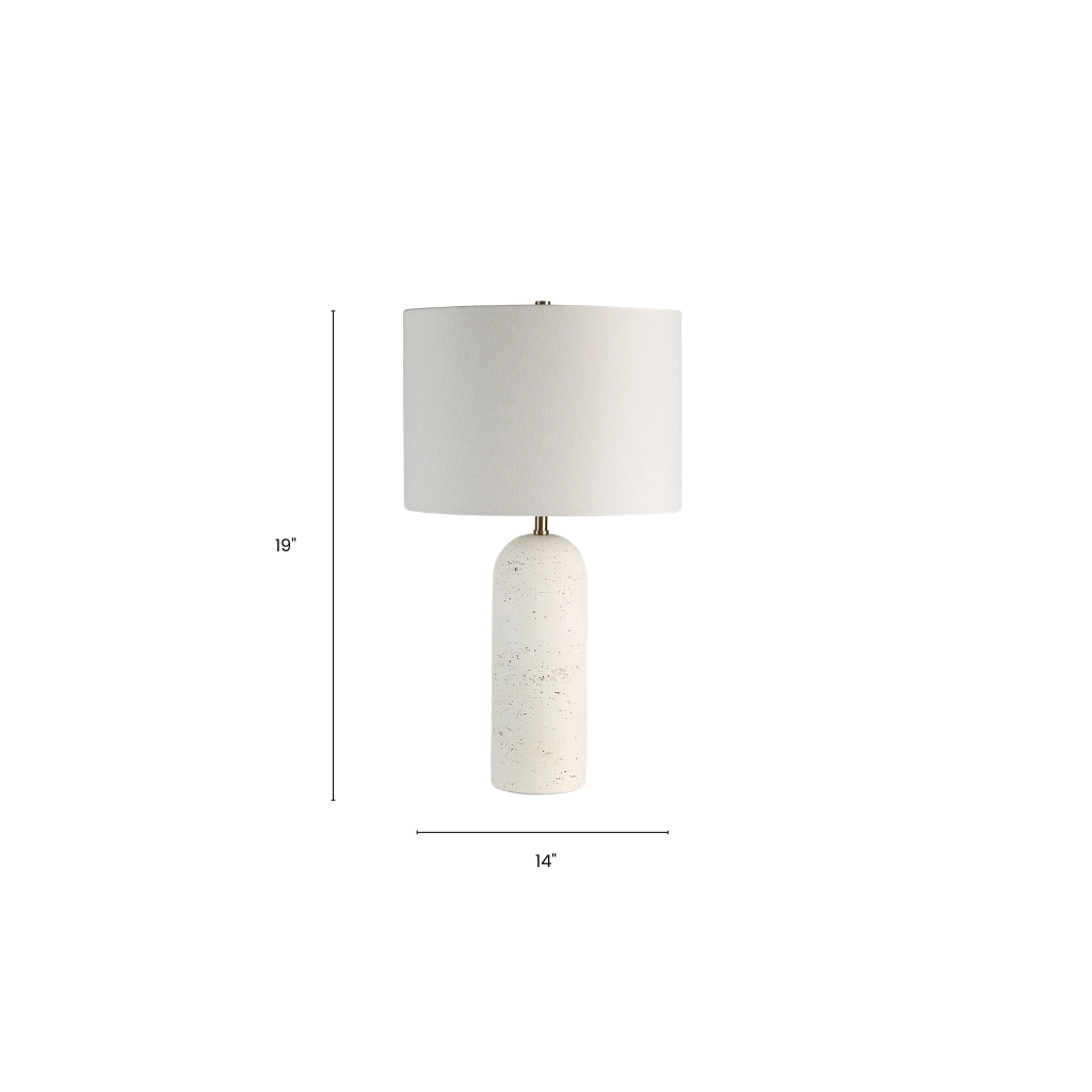 Table lamp with a white shade and textured base on a white background