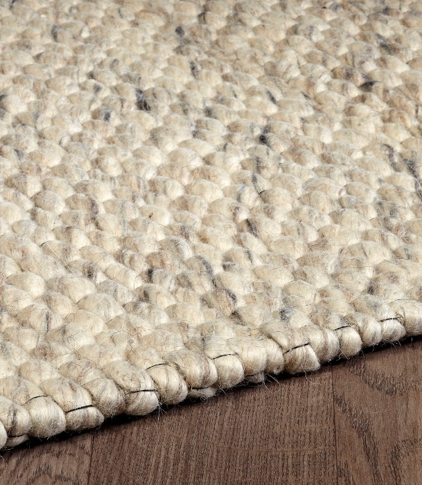 Angled close-up highlighting the thick, woven loop texture of the Silas wool rug in ivory