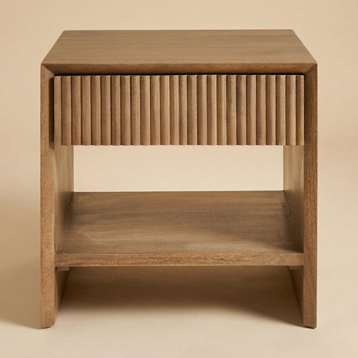 Front studio view of the Silva nightstand featuring solid mango wood construction and a vertically fluted drawer front.