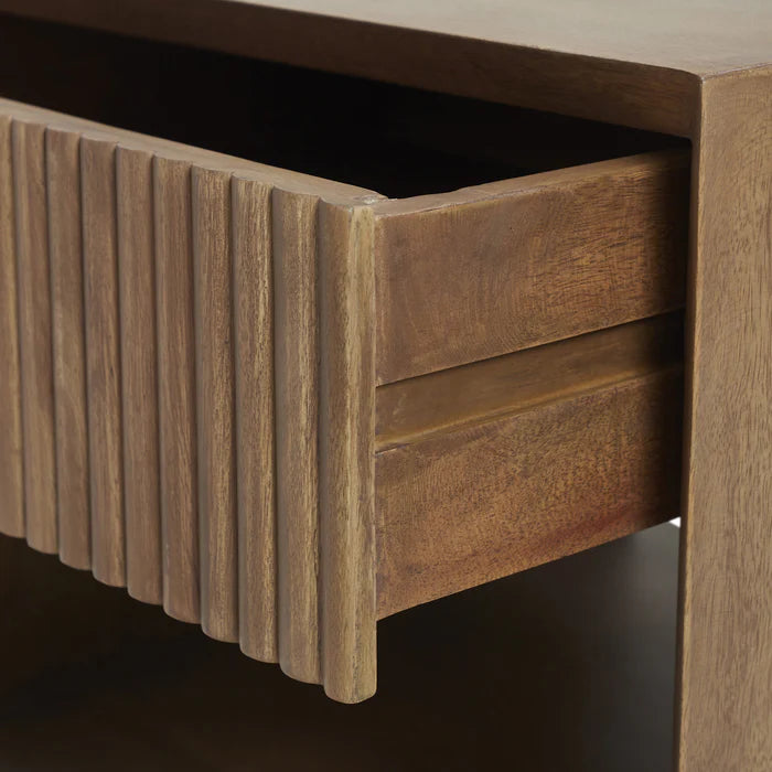 Close-up macro shot of the Silva nightstand showcasing the intricate vertical fluting detail and natural mango wood texture
