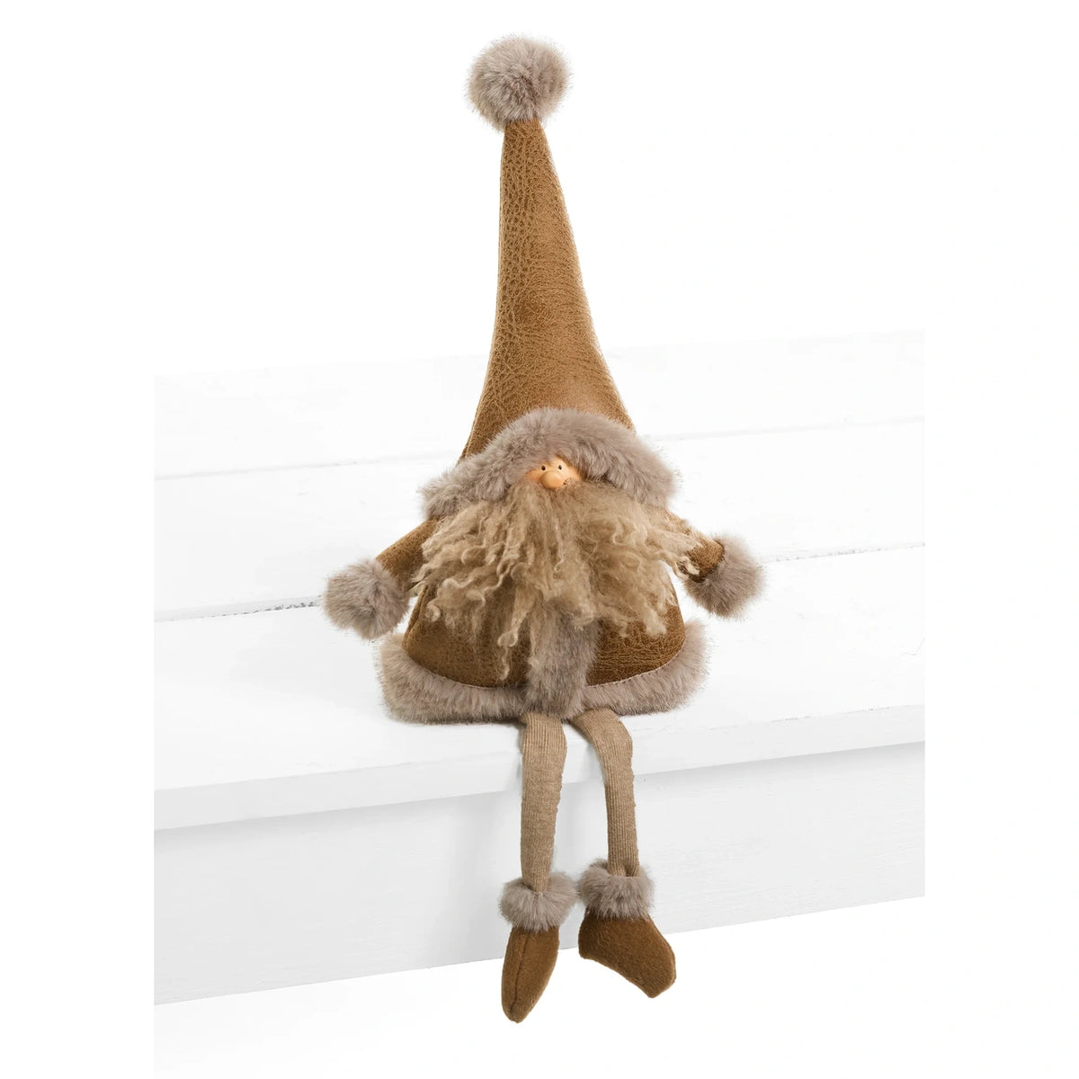 A brown and beige Christmas gnome doll with a long pointed hat, shaggy beard, and dangling legs, sitting on a white wooden step against a white background.