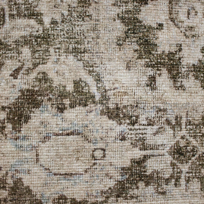 Close-up of the Thea Rug showing the faded floral medallion pattern in beige and olive tones