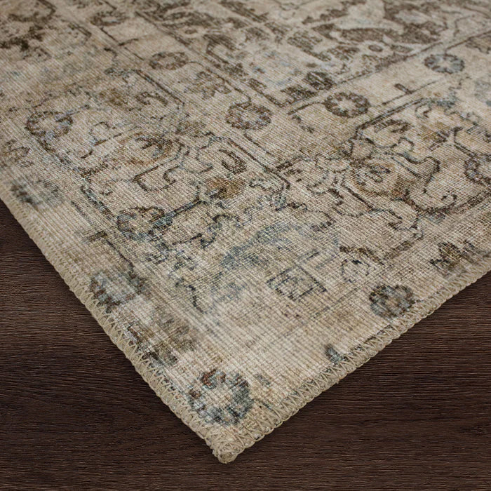 Close-up of a textured area rug with a geometric pattern on a wooden floor.