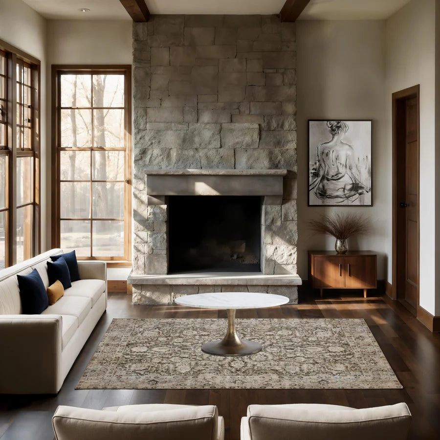 Modern living room with stone fireplace, white sofa, and wooden floor.