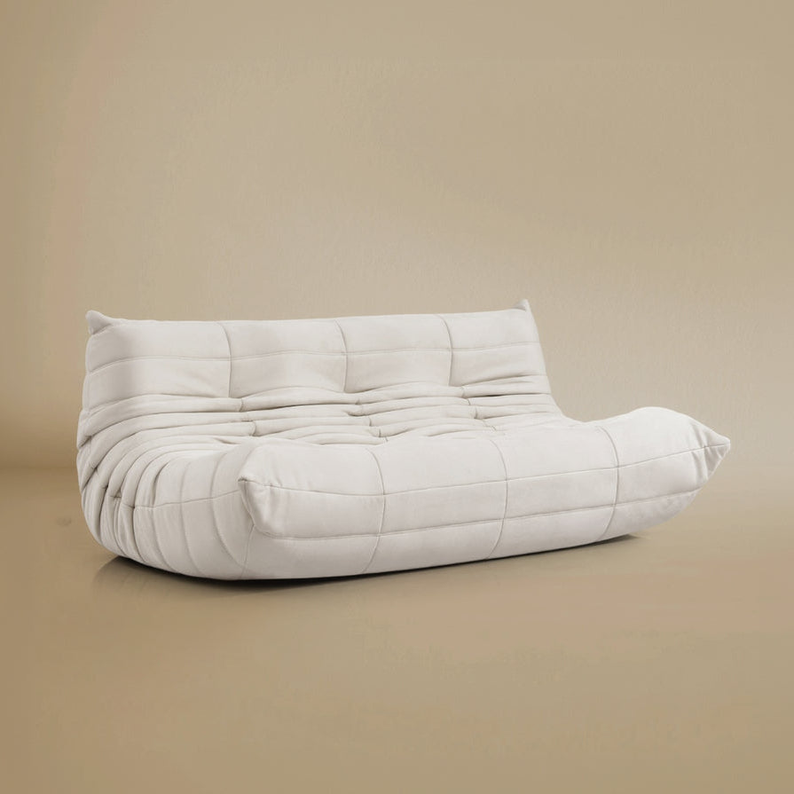 Angle view of the TOGO Three Seater Lounger in a light beige studio background