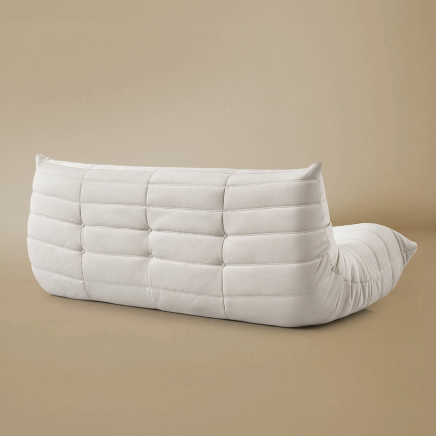 Back view of the TOGO Three Seater Lounger in a light beige studio background