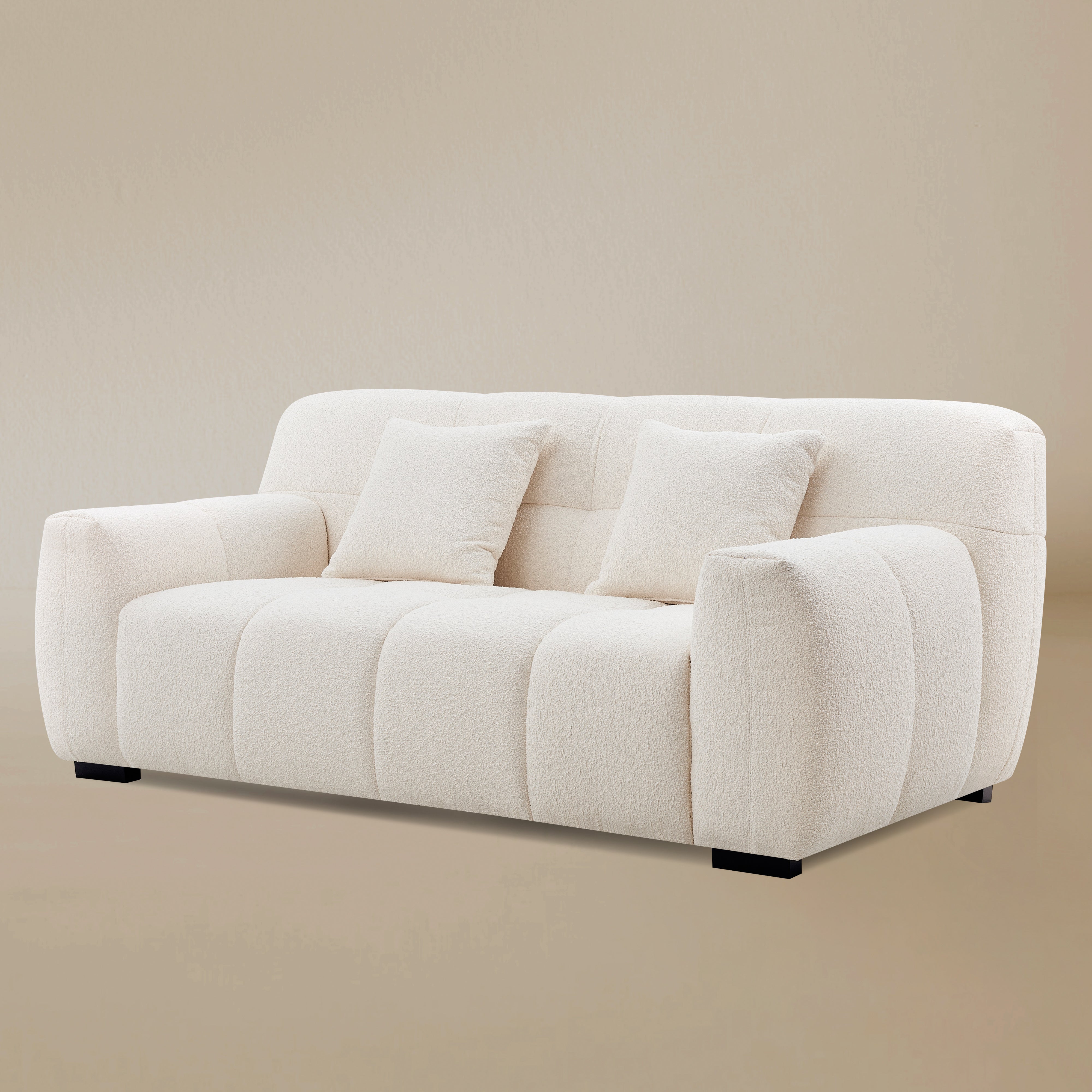 Angled studio shot of the Gummy sofa emphasizing the depth of its cushions and its modern, sculptural form.