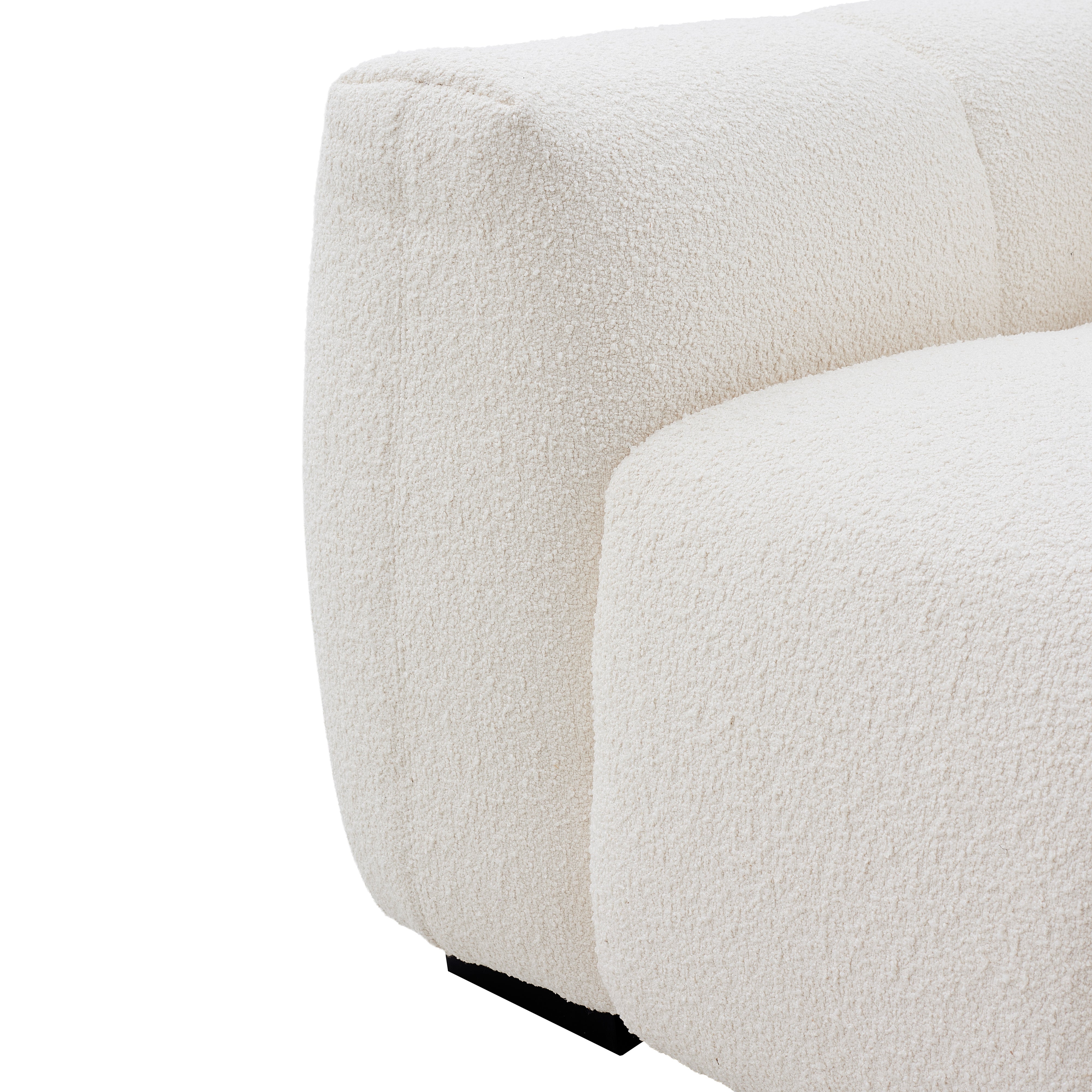Macro close-up of the Gummy sofa highlighting the deep vertical tufting and the rich texture of the cream bouclé.