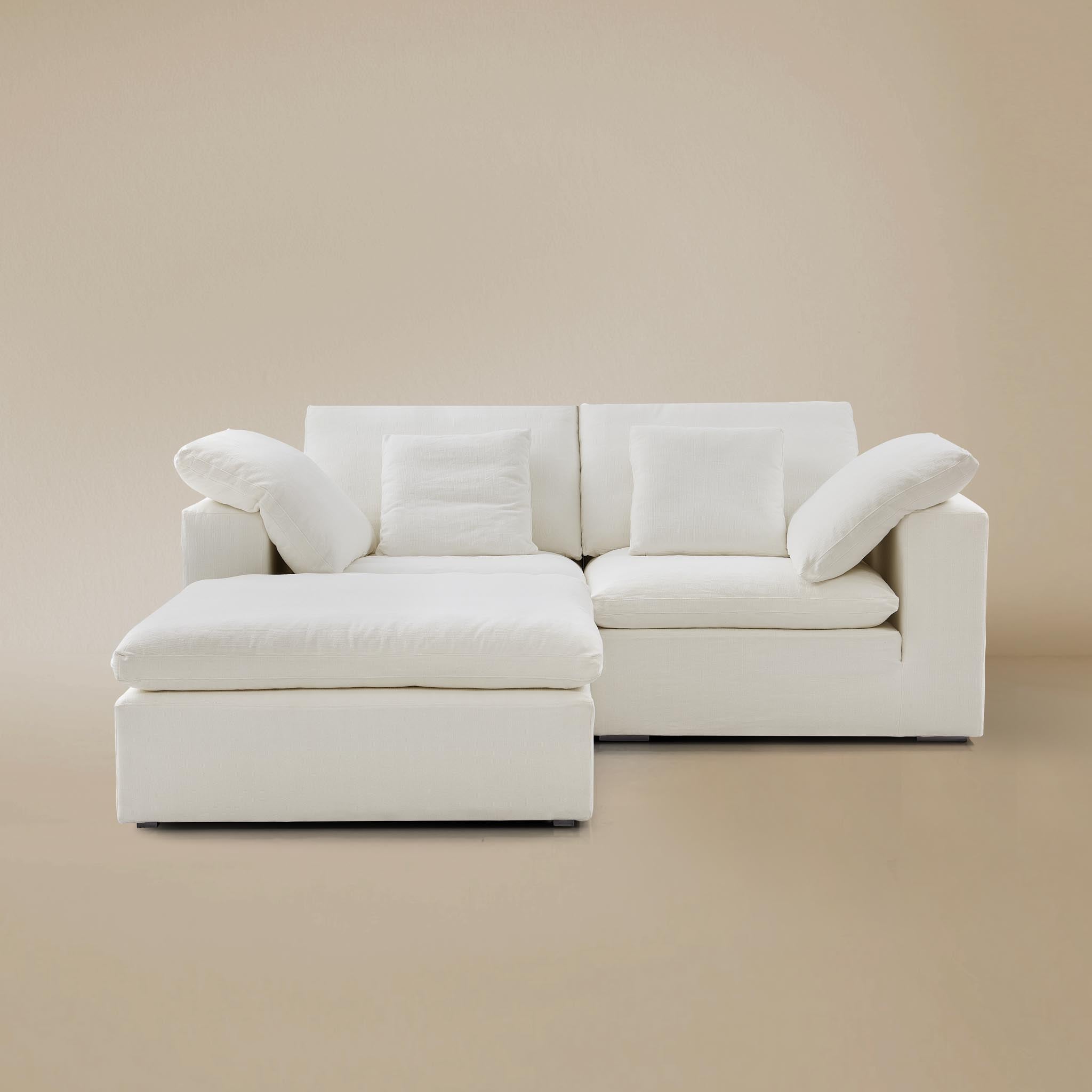 Ultra softness modular sofa two seater with ottoman on a beige studio background