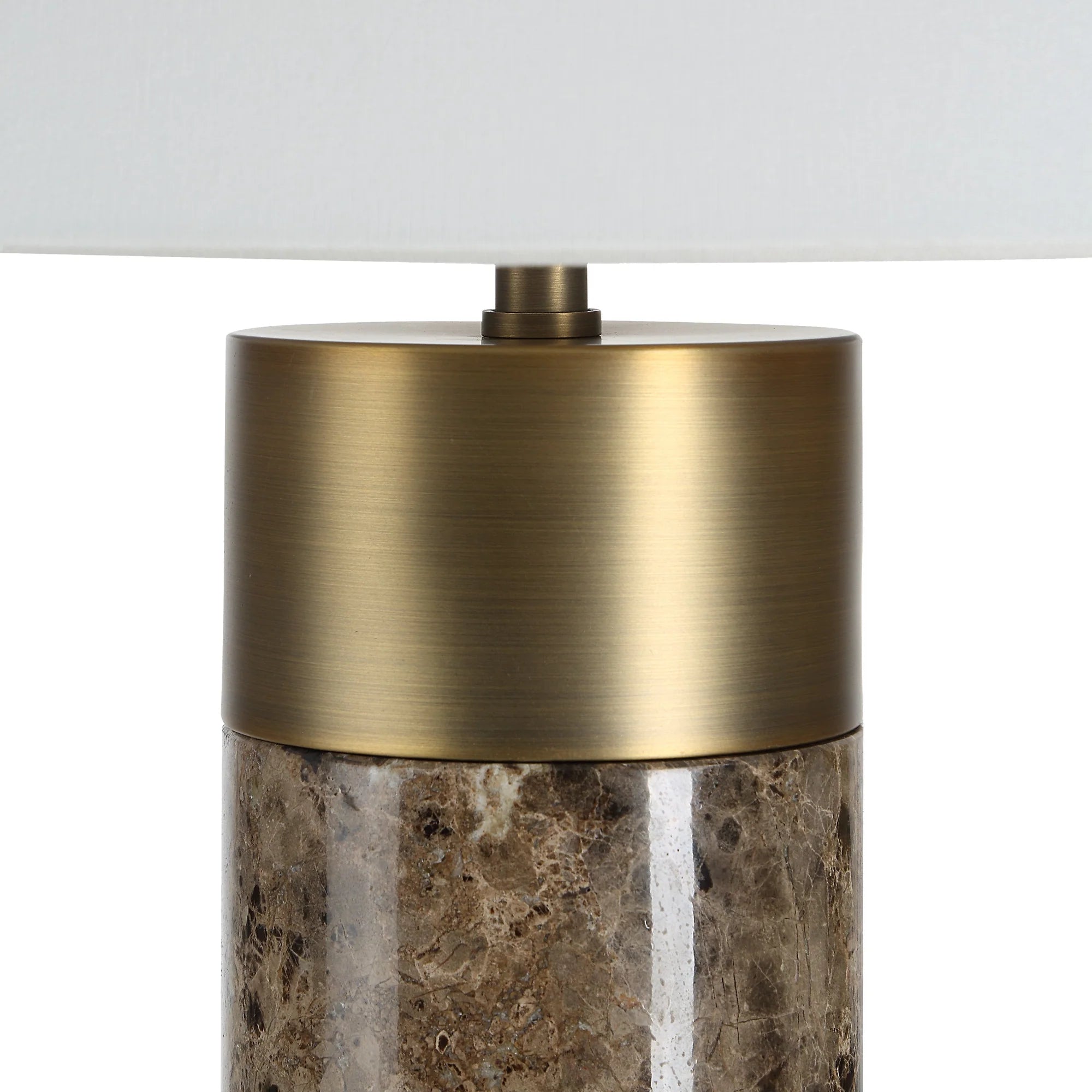 Macro close-up of the Valance lamp highlighting the contrast between the polished brown marble and the brushed brass metal finish.