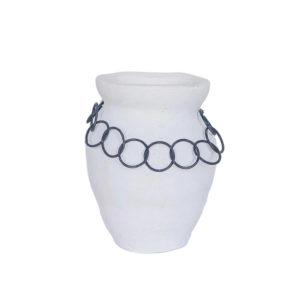 White vase with a black chain-like decorative element on a white background