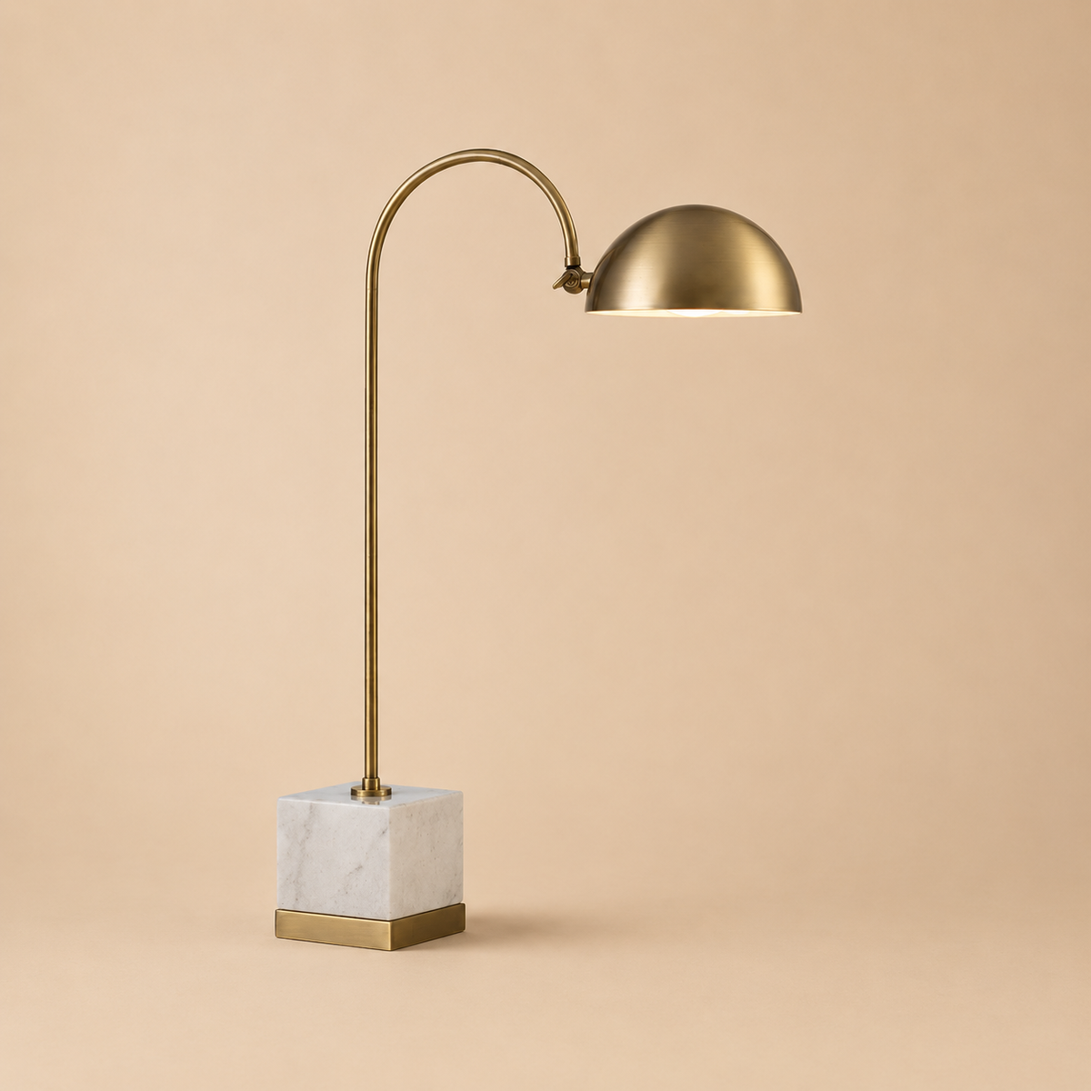 Vance Arched Table Lamp – gold table lamp with marble base on a beige background