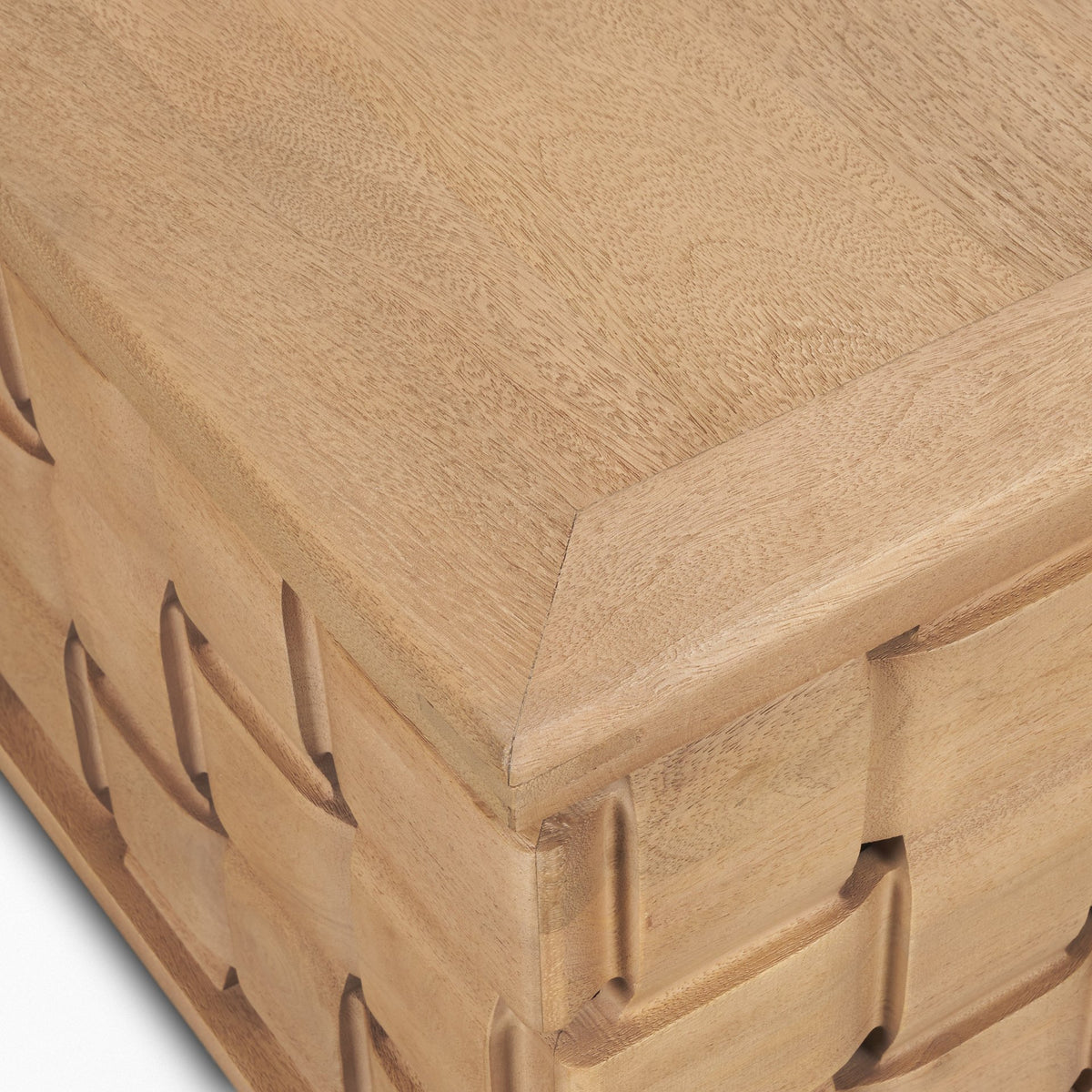 Close-up corner detail of the Varelle Coffee Table showing the solid mango wood top and carved woven base meeting at the edge.